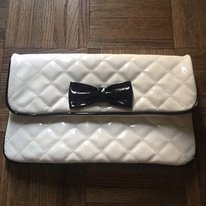 White quilted black bow clutch